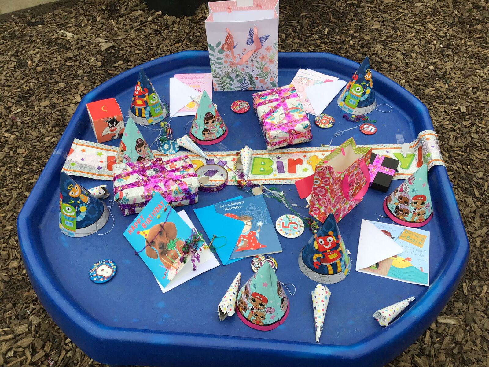 A tuff tray covered with children's handmade Christmas cards