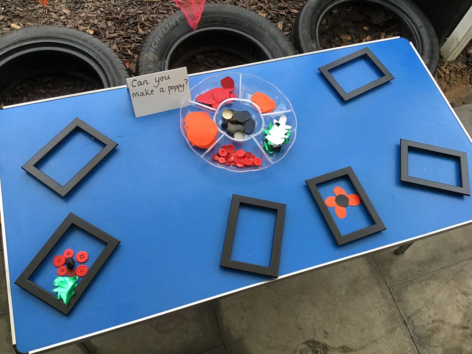 Poppy craft materials and picture frames laid out on a table
