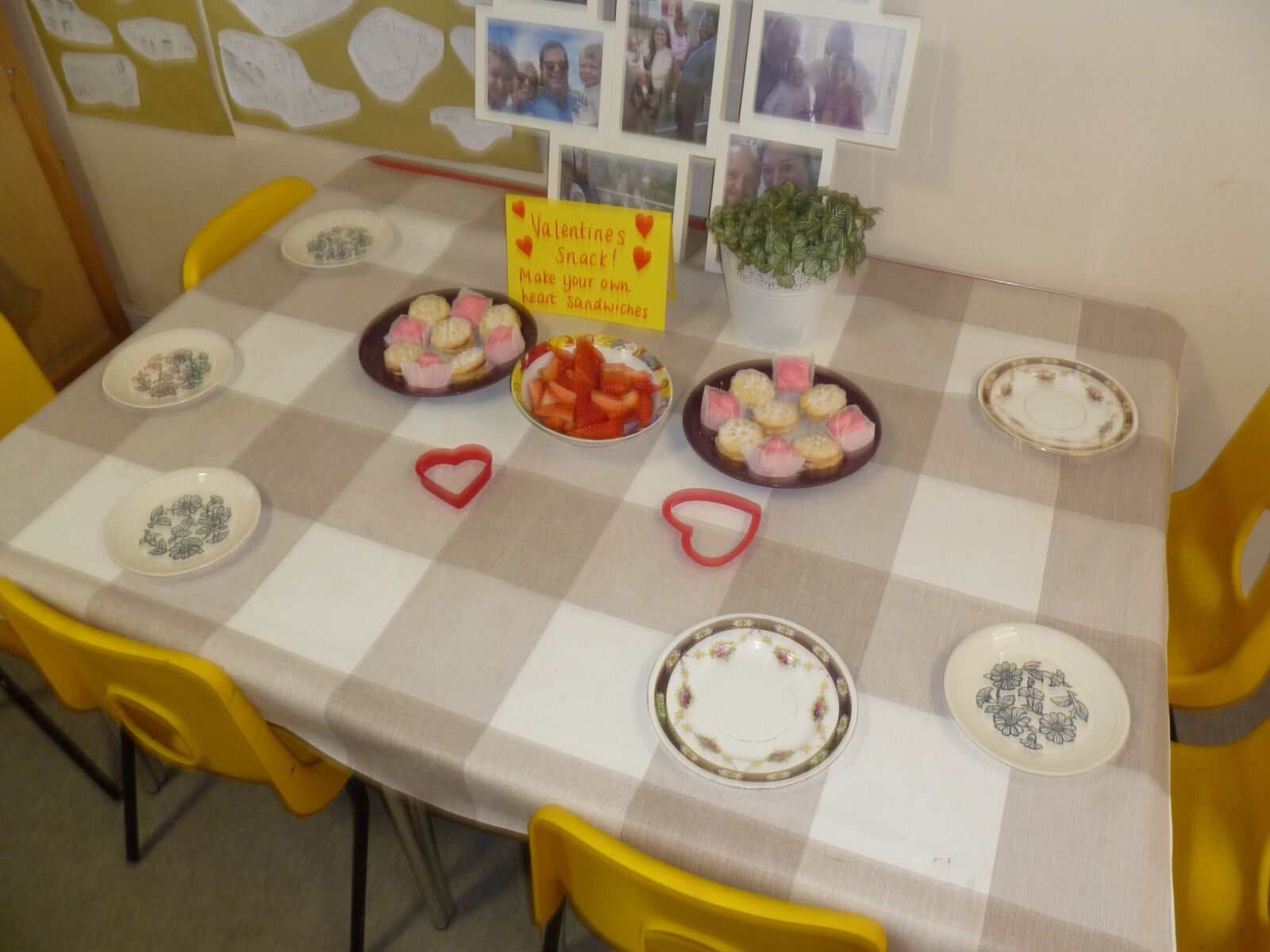 A table laid out for a tea party with plates and dough cakes