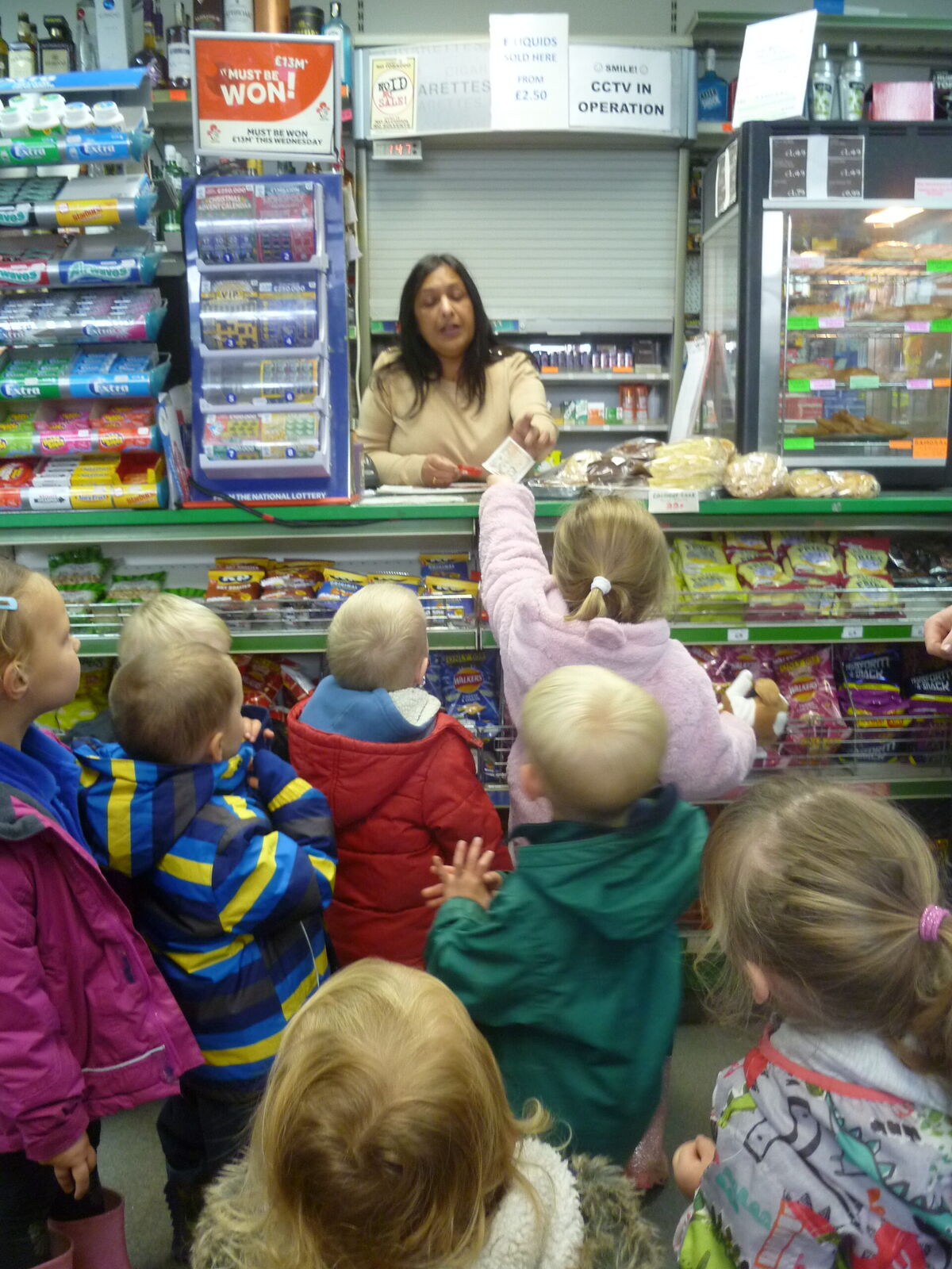 A group of children visiting the village shop